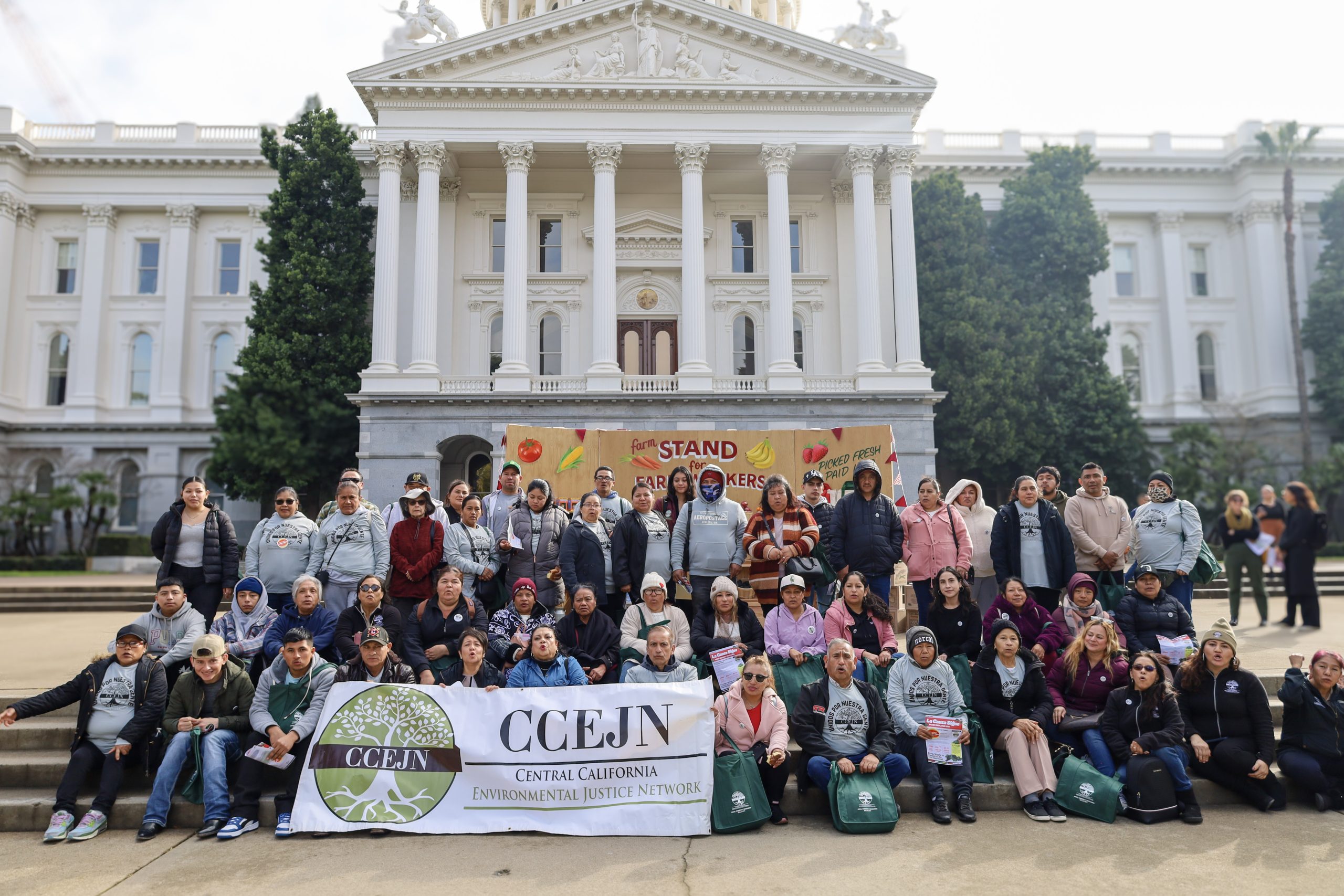 CCEJN community members and farmworkers gathered at the California State Capitol holding a banner in support of farmworkers