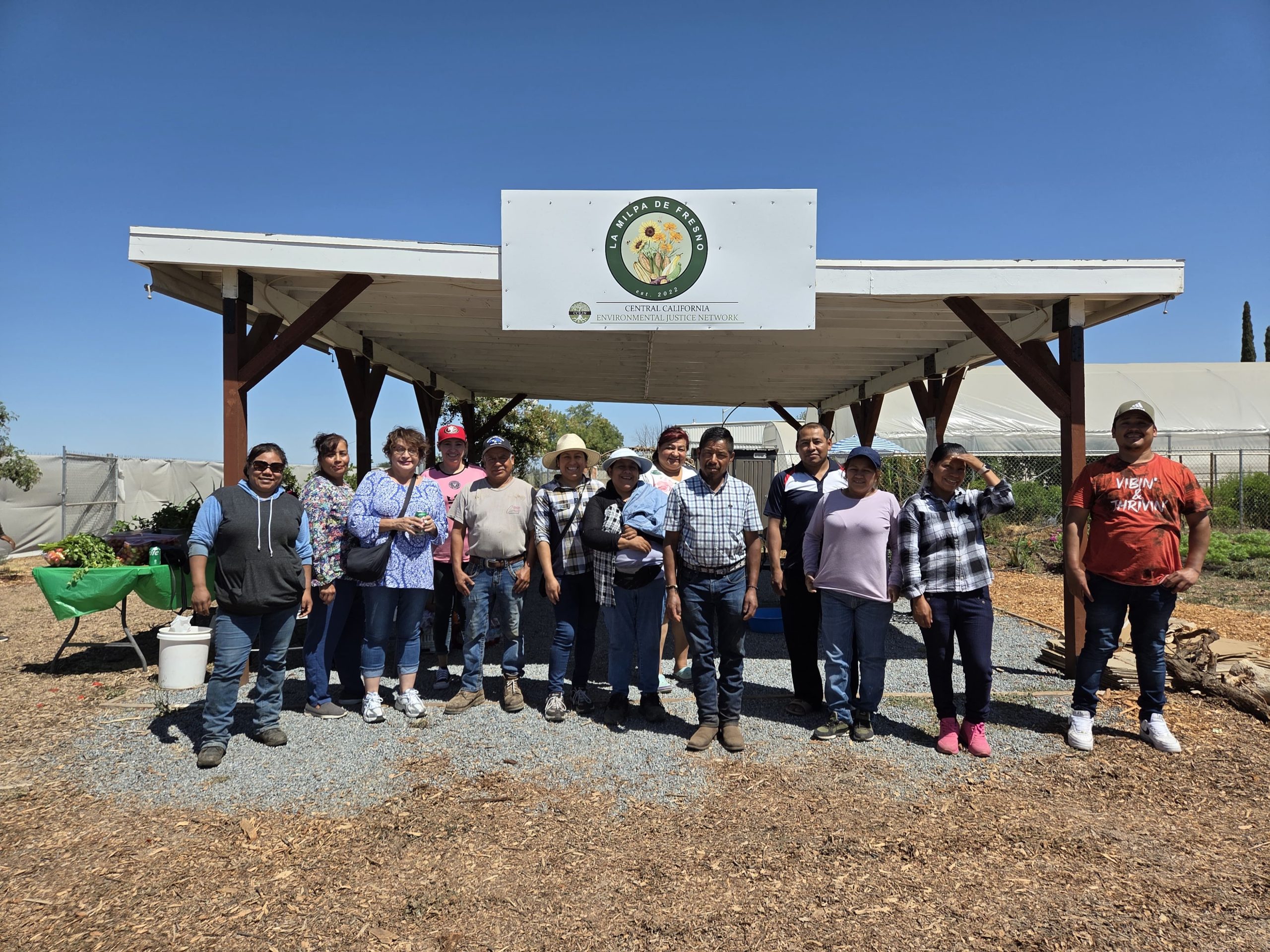 Farmers gathered under the La Milpa de Fresno shade structure at the community farm